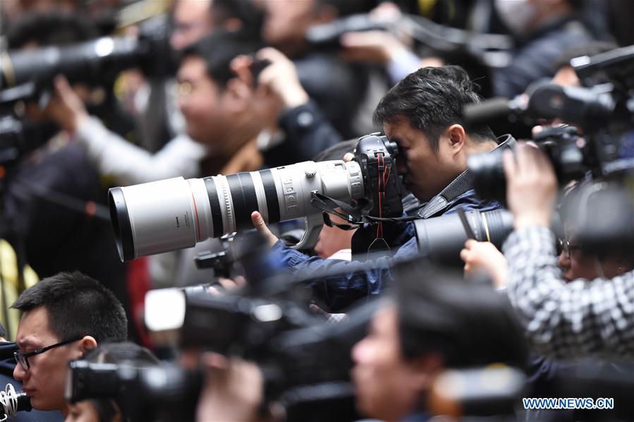 Photographers work at the closing meeting of the fifth session of the 12th National Committee of the Chinese People's Political Consultative Conference at the Great Hall of the People in Beijing, capital of China, March 13, 2017. Photo: Xinhua