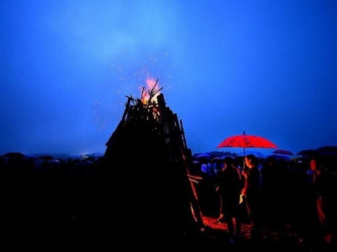 People gather around bonfire in camping festival, China's Hubei
