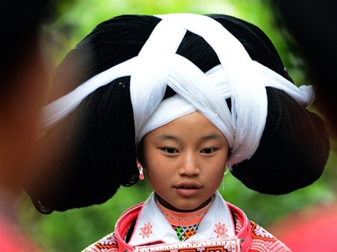Long-horn Miao girls with huge headdresses