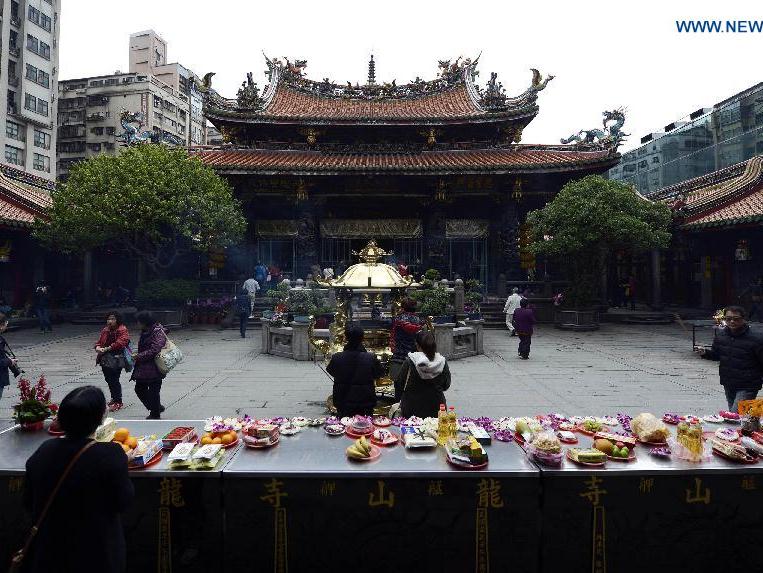 People pray at Lungshan Temple in Taipei